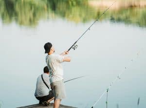 Relaxed young boy fishing on calm river at Surf Coast, Great Ocean Road local spot.